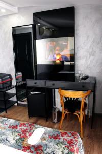 a computer desk with a television on top of it at Istanbul Fair Hotel in Istanbul