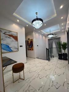 a room with a chair and a painting on the wall at Bricks Residence in Lekki