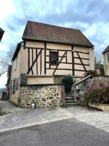 uma casa velha com as palavras vida ao lado dela em Maison face à l'eglise em Toucy