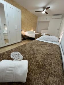 a bedroom with two beds and a large rug at SACABA BEACH SWEET in Málaga