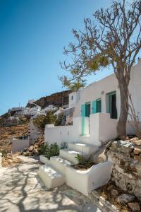 a group of stairs in front of a building with a tree at Serifos Sugar Cubes in Serifos Chora