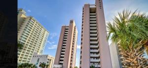 two tall buildings in a city with palm trees at Ocean Front 53 Steps in Myrtle Beach