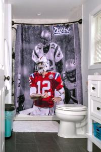 a shower curtain of a football player in a bathroom at Twin XL Bed - Boston - RM 1 in Stoneham