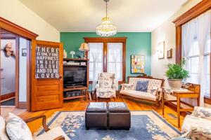 a living room with a couch and a tv at Ye Olde Walkerville Bed & Breakfast in Windsor
