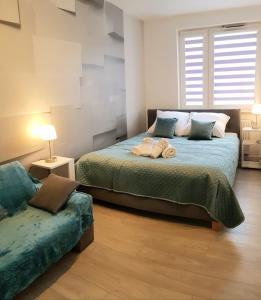 a bedroom with two beds and a couch at Apartment DAISY, balcony, 5 os, Down Town in Kraków