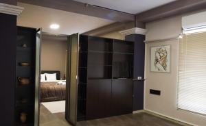 a room with a sliding glass door with a bed at Hotel Ambasador in Bitola