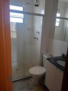 a bathroom with a shower and a toilet and a sink at Nosso Lar-Ap Rio das Ostras in Rio das Ostras