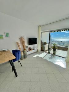 a living room with a view of the ocean at Ocean Kiss Apartment in Puerto del Carmen