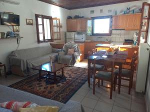 a living room with a couch and a table at Rodomelo House - 3 Bedrooms in Leonidio