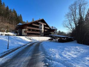 a large building in the snow with a road at Dream Apartments No.202 - Right in the heart of Tále in Tale