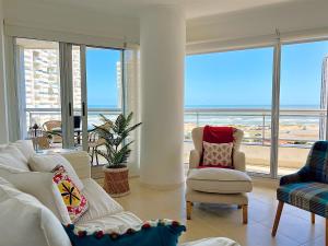 a living room with a view of the ocean at South Beach Apartment in Punta del Este