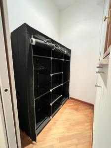 a closet with black shelves in a room at Appartamento Cenisia Fermata Racconigi in Turin