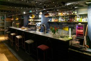 a bar in a restaurant with stools at ho36 La Plagne in La Plagne