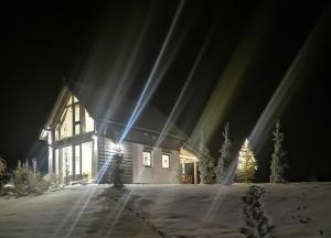 a house in the snow at night at BABIE LATO dostęp do jeziora UBLIK in Konopki Wielkie