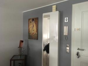 a hallway with a mirror and a white cabinet at Charming & Cosy duplex - city in Luxembourg