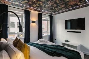 a bedroom with a bed and a tv on a ceiling at WelcomeStay Fitzrovia Two Bed Apartments - Sleep in Opulent Luxury in London