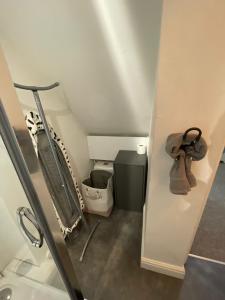 a bathroom with a sink and a trash can at Spacious sofa bed lounge area with ensuite bedroom in Wednesbury