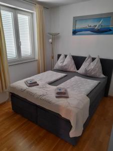 a large bed in a room with a bed sidx sidx sidx at Apartment Adi in Rovinj
