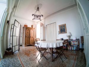 a dining room with a table and chairs in a room at Blue Room Shared House Terrace above in Genoa