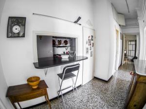 a kitchen with a counter and a chair in a room at Blue Room Shared House Terrace above in Genoa