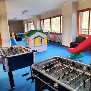 a play room with a foosball table and a playground at Nic snow house in Roccaraso