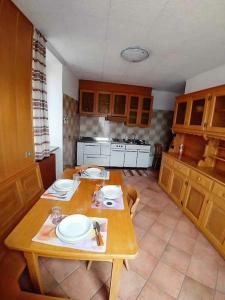 een keuken met een houten tafel met borden erop bij da Stoimenov in Fondo