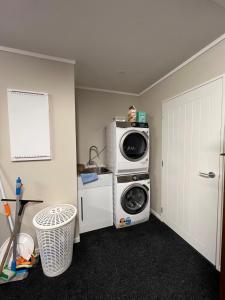 a laundry room with a washing machine and a washer at Beautifully presented home in Richmond