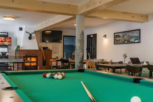 a pool table in the middle of a living room at Ceprówka Family Friendly in Białka Tatrzańska