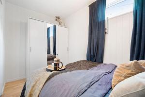 a bedroom with a bed and a large mirror at Charming, Central, Coffee Machine in Ålesund