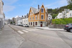 a large yellow house on the side of a street at Charming, Central, Coffee Machine in Ålesund
