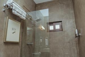 a shower with a glass door in a bathroom at Casa Emiliana in Valle de Guadalupe
