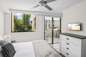 a bedroom with a bed and a ceiling fan at 303 Temple Tranquility Triton Retreat in Palm Cove