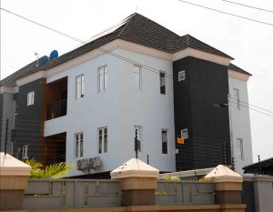 a large white house with a black at Delight Apartments in Lagos