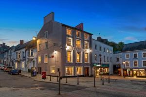 a group of buildings on a city street at night at Castle Hotel Haverfordwest in Haverfordwest