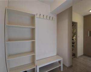 a walk in closet with white shelves at Apartments Křišťanova in Prague