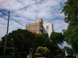 a tall building with trees in front of it at Departamento Nuevo 2 amb con cochera Solo parejas o familias in Mar del Plata
