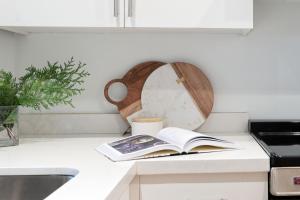 a kitchen counter with a book and a clock at Slopeside Whistler Creek in Whistler