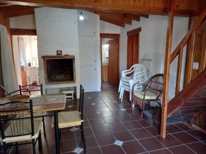 a living room with chairs and a table and a fireplace at Maneki in La Paloma +4 photos