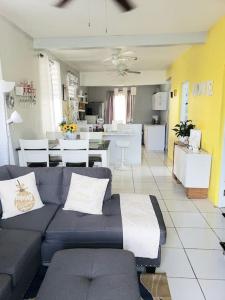 a living room with a couch and a kitchen at Casa Amalia Beach House in Aguada