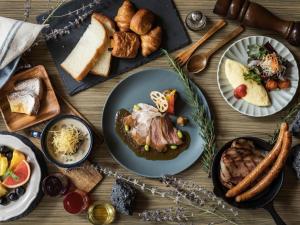 a table topped with plates of food and bread at Sapporo View Hotel Odori Park in Sapporo
