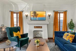 a living room with a blue couch and a fireplace at Visit the Beach from a Historic Downtown Apartment - NRP21-00092 in Long Beach