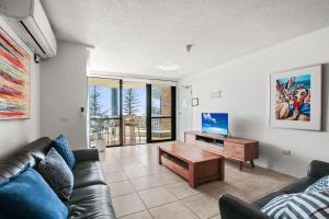 a living room with a couch and a table at Seapoint Unit 14 32 Victoria Tce Kings Beach in Caloundra