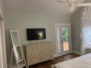 a bedroom with a dresser with a television on it at WELCOME TO BURNT RIVER ESTATE in Kawartha Lakes