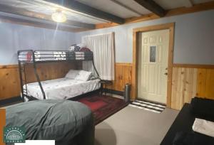 a room with a bunk bed and a door at Cozy Cabin at Cloverdale Cabins in Hinckley