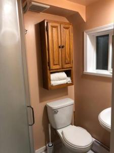 a small bathroom with a toilet and a sink at Shady Willow Guest House -Coach house & Privet Small Compact Rooms with separate entrance in Chilliwack