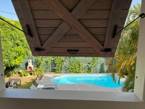a patio with a hot tub under a wooden ceiling at DUCHARMOY LODGES in Saint-Claude