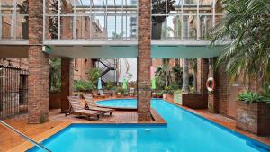 an indoor swimming pool in a building with a patio at Gordon House Apartments in Melbourne