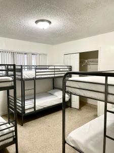 a room with three bunk beds and a mirror at Miami House in Miami