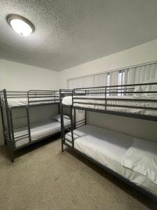 two bunk beds in a room with a ceiling at Miami House in Miami