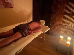 a man laying on a couch in a bath tub at DOMO Y SPA INFINITO in Catillo